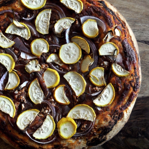 Photo of homemade vegan pizza topped with summer squash